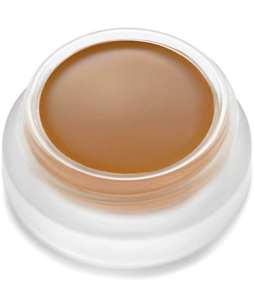 Kleiner Behälter mit hellbrauner Creme oder Gel, offen, auf weißer Oberfläche.