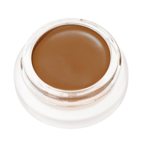 Ein kleiner Behälter mit brauner Creme oder Make-up, runde Form und durchsichtigem Deckel.