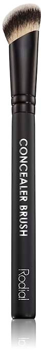A black makeup brush with a rounded tip and the words 'CONCEALER BRUSH' written on the handle.