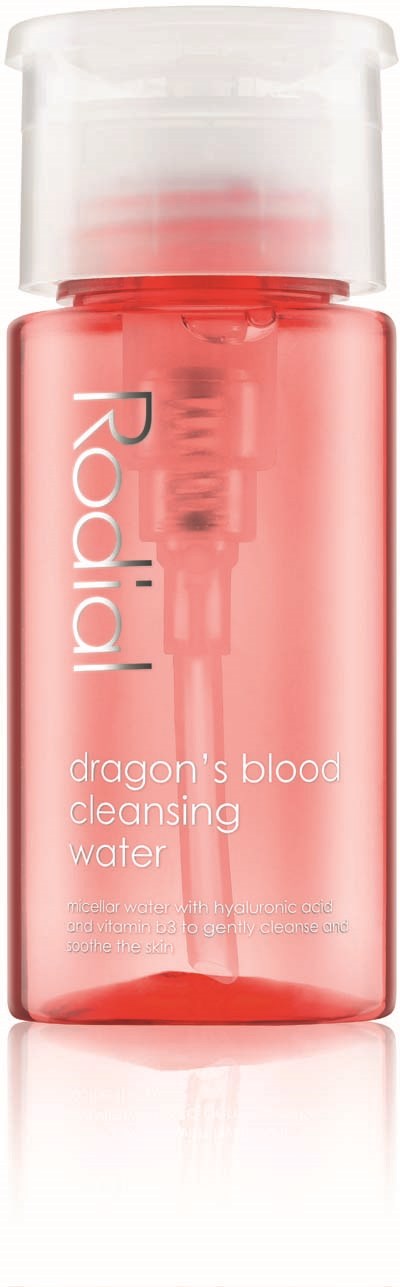 A small red bottle with a clear cap, labeled 'Reaij' and 'dragon's blood cleansing water.'