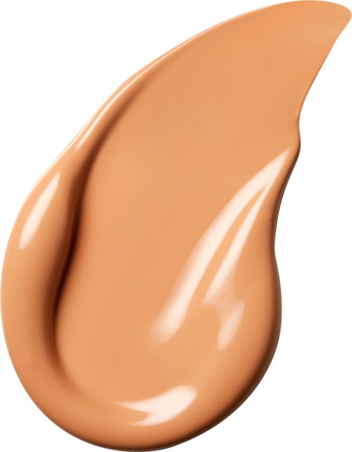Et dråpe med beige væske som har glatt, blank overflate og buet form.
