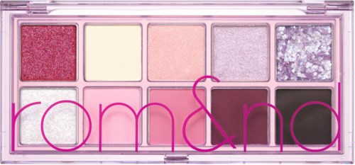 A palette with pink, purple, white, and black eyeshadows; most have shiny or glittery finishes.