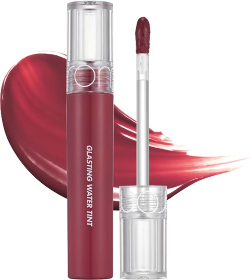 Een lippenstiftfles met kwast, met een grote rode hart erachter.