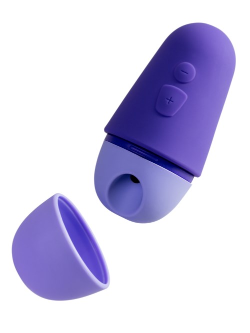 Ein kleines lila Gerät mit Tasten, einem Deckel und einer Öffnung unten, sieht aus wie ein tragbarer Lautsprecher oder Gadget.