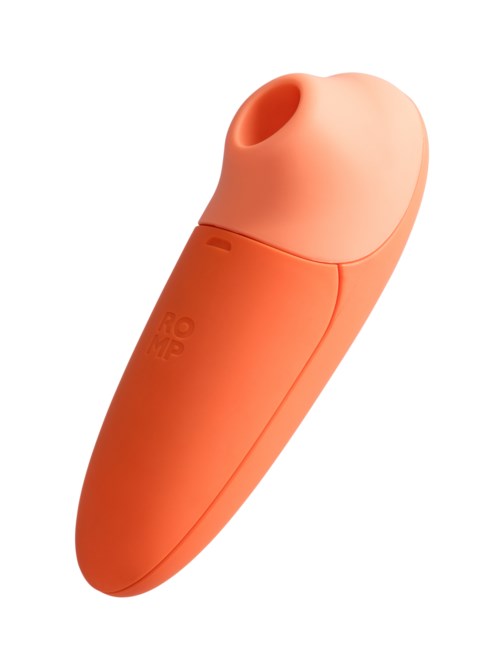 A small, orange device with a rounded top and a hole, likely a personal care or health product.