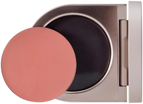 A compact round makeup sponge and a container with open black lid inside.