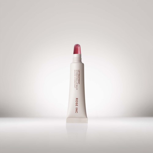 A tube with pink lipstick, standing upright, labeled with brand and product details, on a plain light background.