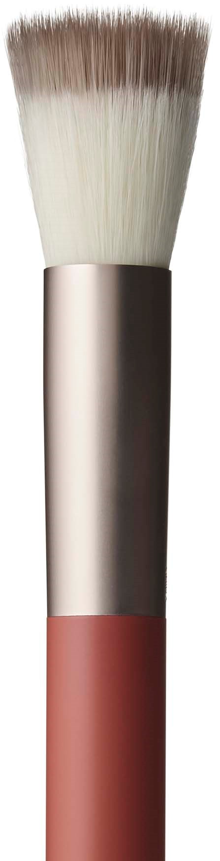 A makeup brush with a beige handle and fluffy white and brown bristles.