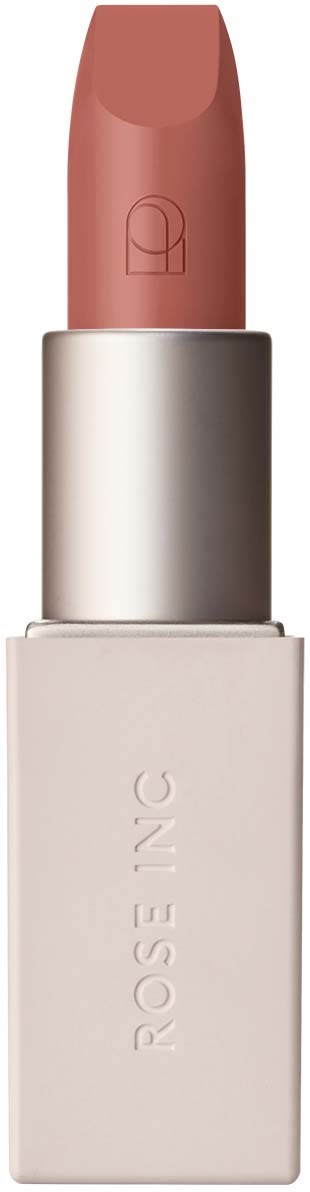 A lipstick with a pale pink color in a silver and white case. The brand name is 'ROSE INC' on the case.