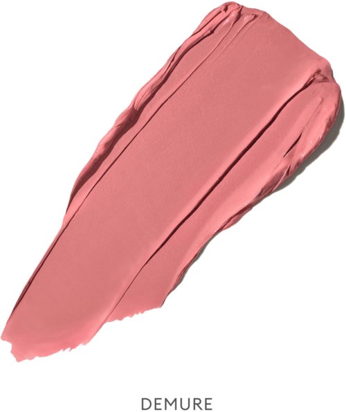A streak of peachy pink cosmetic cream with a smooth texture and a slight shine.