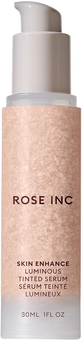 A tall, white bottle with pump, labeled Rose Inc Skin Enhance Luminous Tinted Serum, 30ml.