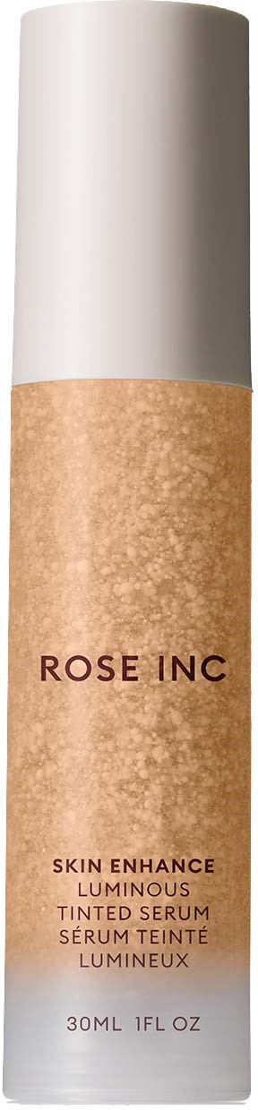 A tall, white bottle with a beige label that says Rose Inc, and mentions skin enhance luminous tinted serum, 30ml.
