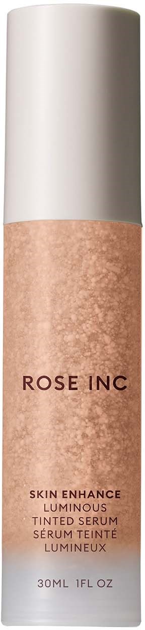 A tall, cylindrical cosmetic bottle with a white cap and a beige body labeled 'ROSE INC' for skin serum.