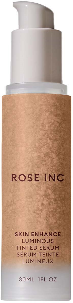A bottle of skin serum labeled 'Rose Inc' with a pump top, beige label, and white cap.