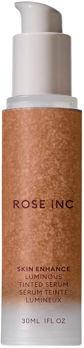 A skincare bottle with a white pump and brown label reading 'ROSE INC' and 'SERUM'.