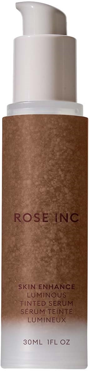 A skincare bottle with a white pump and a brown label that says "ROSE INC" and "LUMINOUS TINTED SERUM."