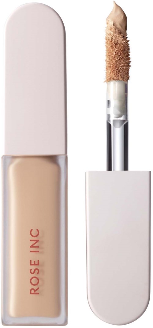 A foundation bottle with an applicator that has a sponge tip. The bottle is white, and the applicator is partly used.