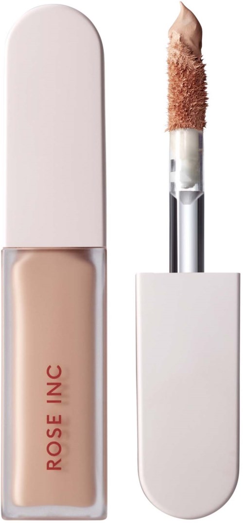 A concealer with a sponge applicator and a container labeled 'ROSE INC' in beige color.
