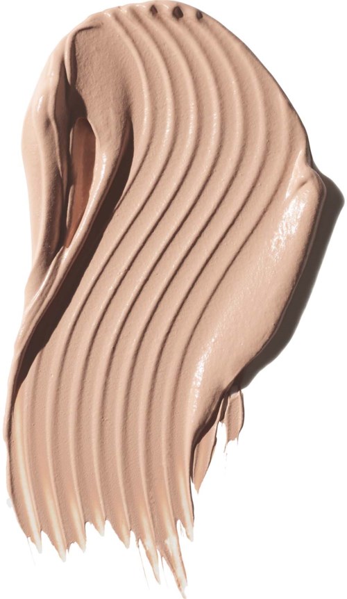 A beige, creamy texture with curved, corrugated lines shows makeup or a cosmetic product.