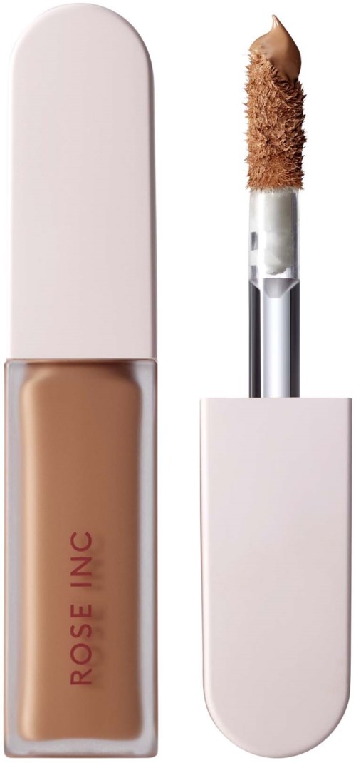 A foundation bottle with a brush applicator showing beige makeup product inside.