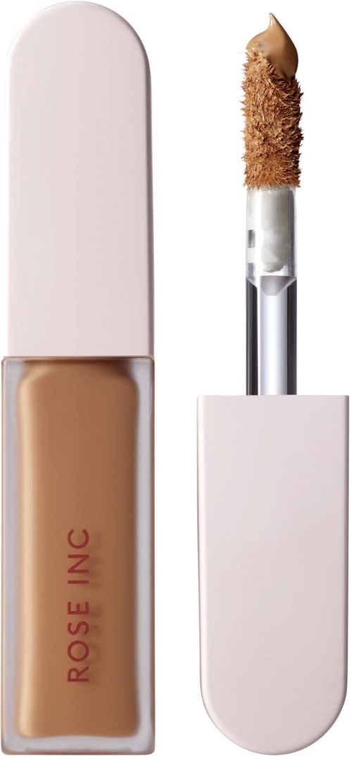 A beige liquid concealer in a small bottle with a white cap, and an applicator with some product on it.