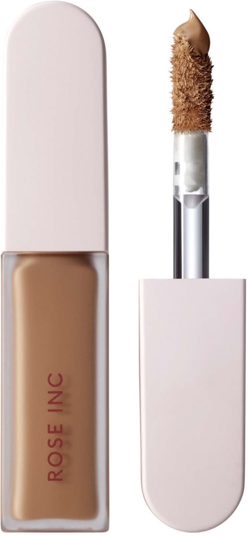 A beige liquid concealer with a white cap, and an applicator with a sponge tip for applying makeup.