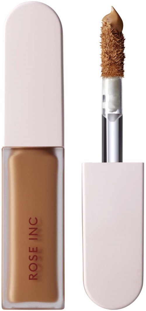 A beige liquid concealer in a white tube with a wand applicator and brown sponge tip.