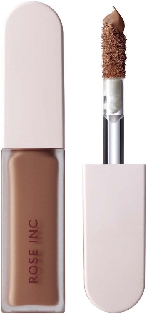 A lipstick with a light pink case and a brownish nude shade, with the applicator removed showing the product.