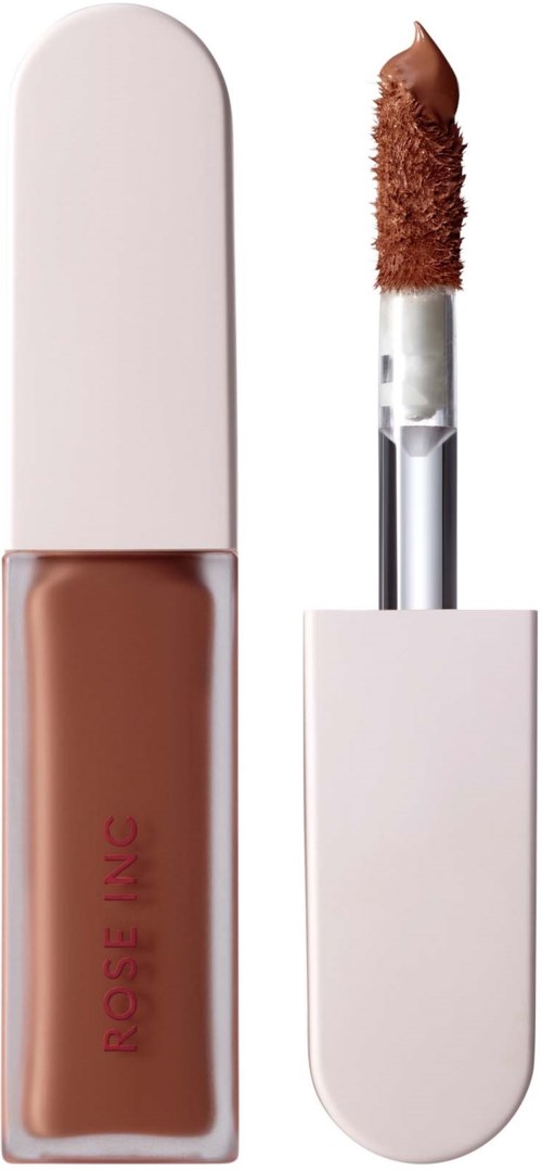 A liquid foundation in a clear bottle with a white cap, and a makeup applicator with a brown sponge tip.