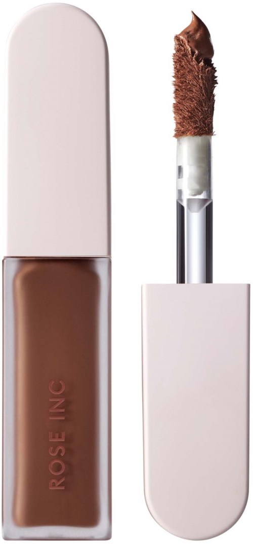 A liquid concealer with a light pink cap and a doe-foot applicator containing brown product.