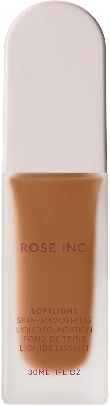 A tube with beige liquid labeled Rose Inc Softlight Skin, lying on a white box.
