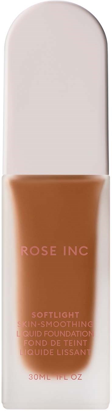 A tube of liquid foundation with brown color and pink text, placed on a white box. It is from Rose Inc.