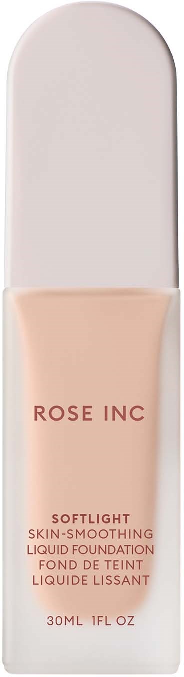 A bottle of liquid foundation labeled 'Rose Inc' with a sleek white cap and beige liquid inside.