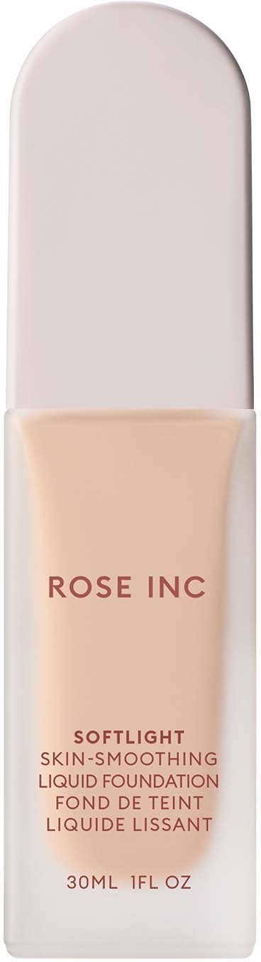 A tube of liquid foundation inside a clear, curved container with white cap. The label reads 'ROSE INC' and product details.