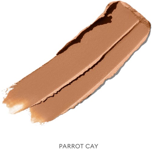 A beige makeup stick, labeled 'Parrot Cay', with a slightly reddish tone and a textured surface.