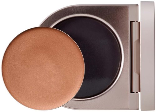 A makeup compact with powder and a brush inside, silver case, open to show the powder and container.