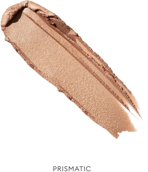 A beige powdery makeup product smudged with a brush, labeled 'Prismatic' at the bottom.