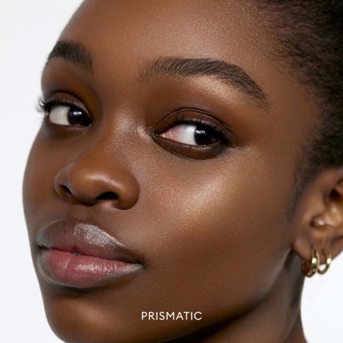 Close-up of a young woman with smooth, dark skin and light makeup, looking confidently at the camera.