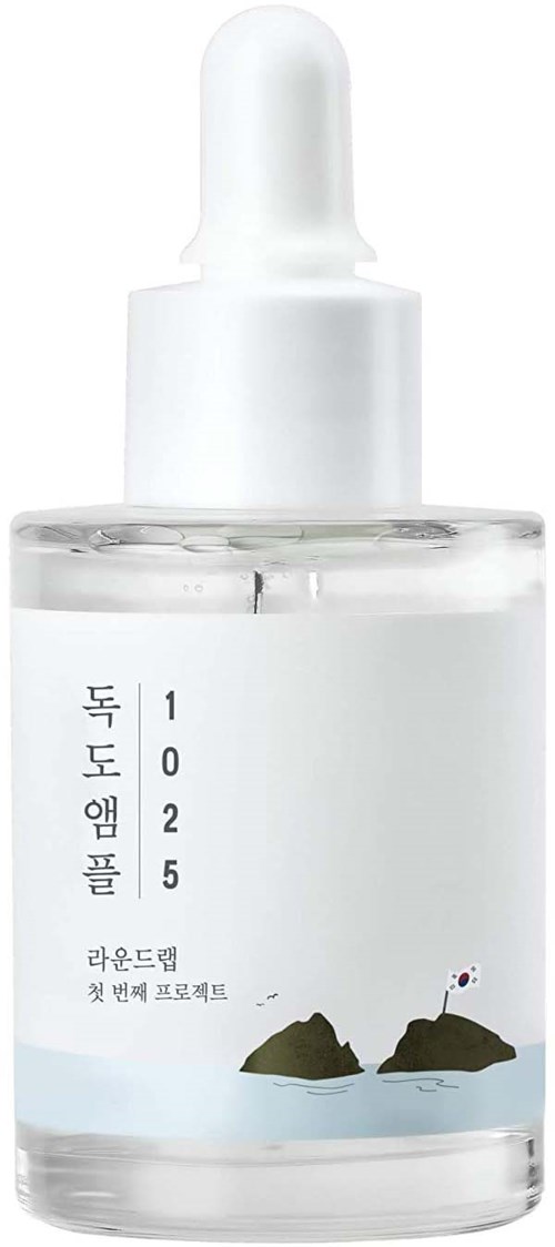 Eine klare Pipettflasche mit koreanischem Text, einem Bergbild und einer kleinen Flagge auf weißem Hintergrund.