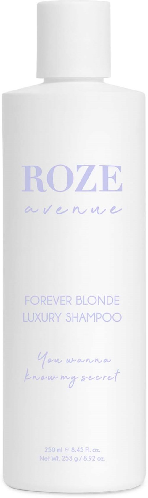 En vit flaska schampo med lila text, märkt "Roze Avenue," för blont hår och lyxanvändning.