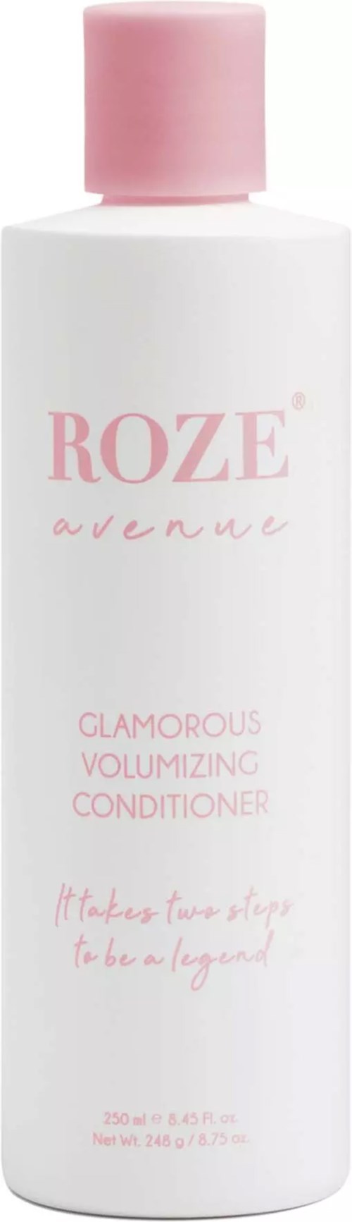 Eine weiße Flasche mit rosa Kappe, beschriftet mit 'ROZE avenue' und 'Glamorous Volumizing Conditioner' in rosa Schrift.