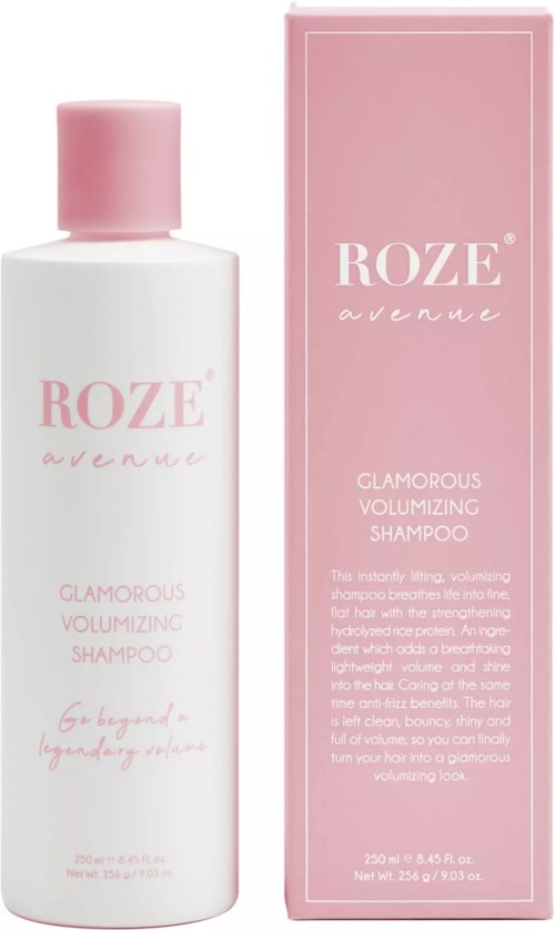 Eine weiße Flasche und eine rosa Schachtel des Roze Avenue Glamorous Volumizing Shampoo, mit sanfter rosa Schrift und Design.