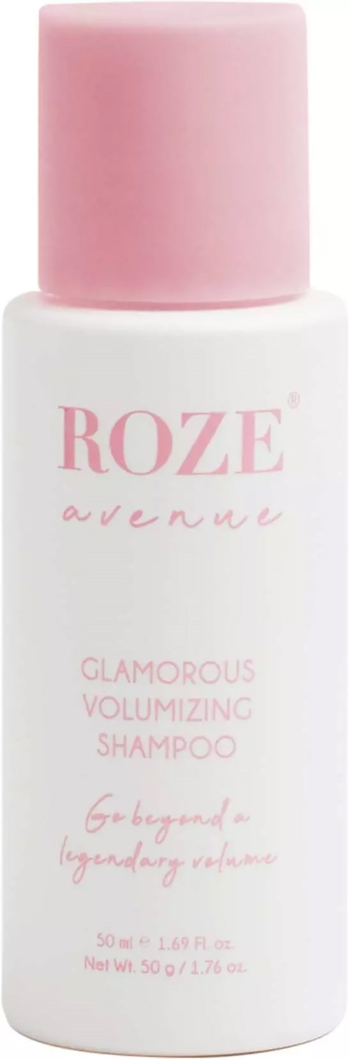 Eine weiße Shampoo-Flasche mit pinkem Deckel, beschriftet mit 'ROZE avenue' und 'Glamorous Volumizing Shampoo'.