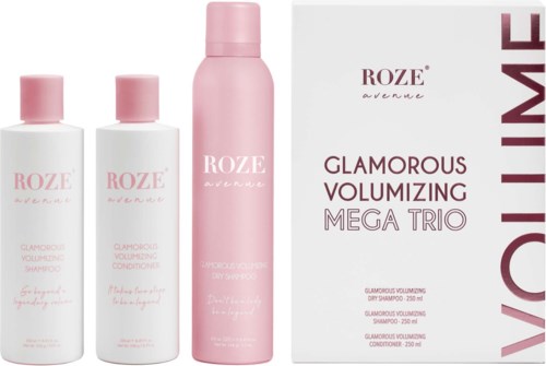 Drei rosa und weiße Flaschen mit Haarpflegeprodukten und eine weiße Box mit der Aufschrift 'Glamorous Volumizing Mega Trio' und Produktdetails.