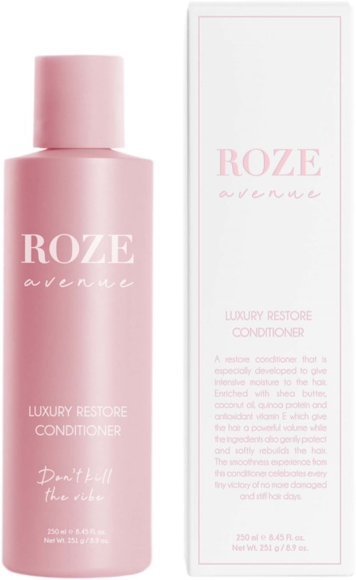 Eine rosa Flasche mit Roze Avenue Conditioner neben einer passenden Schachtel. Die Flasche ist lang und zylindrisch.