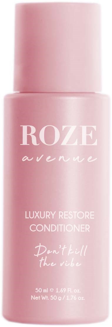 A pink bottle of ROZE Avenue luxury restore conditioner with white text and a flip cap.
