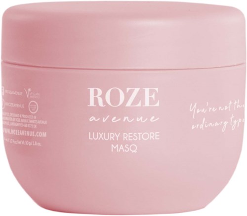 Ein rosa Behälter mit der Aufschrift 'ROZE avenue Luxury Restore Masque' und anderem Text.