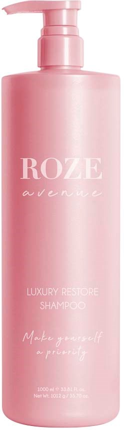 Eine rosa Shampoo-Flasche mit Pumpe, beschriftet 'ROZE avenue' und 'Luxury Restore Shampoo'.