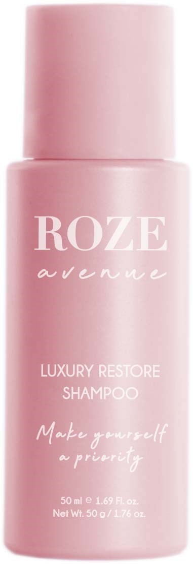 Eine rosa Flasche mit Rozé Luxus Restore Shampoo mit weißem Text und rundem Deckel.