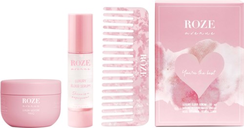 Rosa Hautpflege-Set mit Creme, Serum, Kamm und Box, alle mit 'ROZE' und 'luxury' beschriftet.